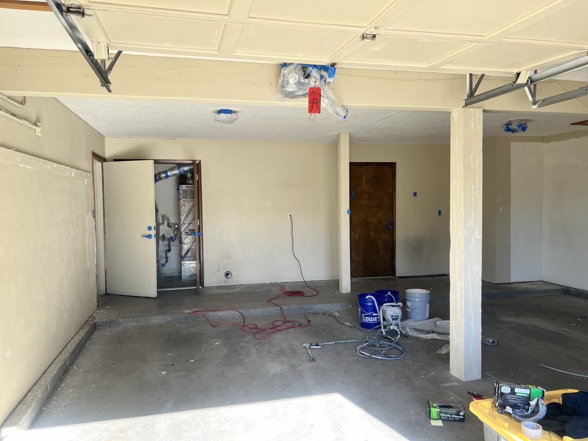 Unfinished garage with stained concrete floor before polyaspartic floor coating in Santa Fe NM